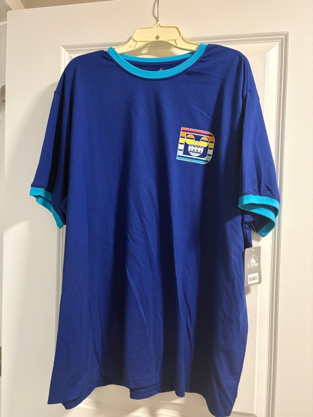 Disney Royal Blue Short Sleeve Tee with Turquoise Trim and Rainbow Patch